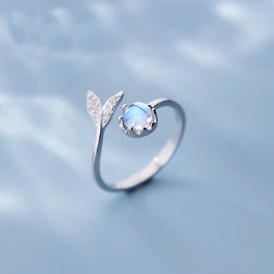 Adjustable ring with dolphin tail made of sterling silver and blue zirconium dioxide